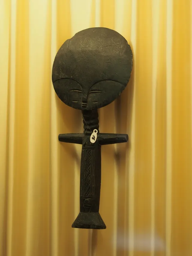 An Akan akua'ba wooden fertility doll from Ghana, with its distinctive flat disc-shaped head