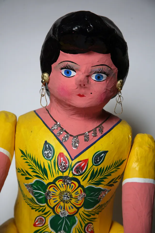 A Mexican cartonería papier-mâché doll in traditional painted dress