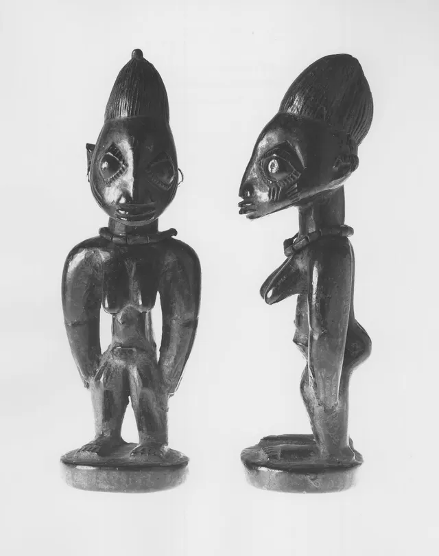 A Yoruba ère ìbejì standing female twin figure, carved wood with beads